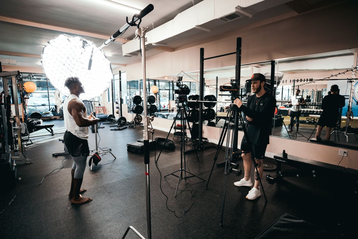 Film crew recording a training session in a gym